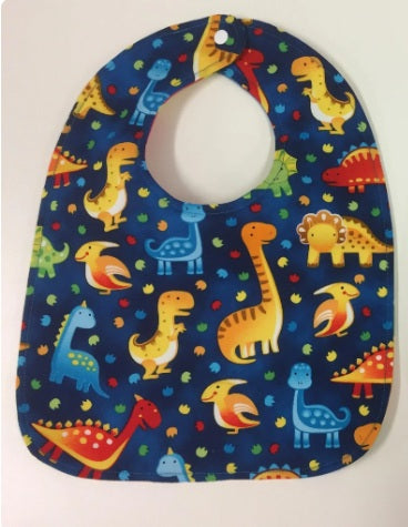 Reversible Bib – Blue Dinosaurs / Yellow with Spots