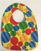 Reversible Bib – Blue Dinosaurs / Yellow with Spots