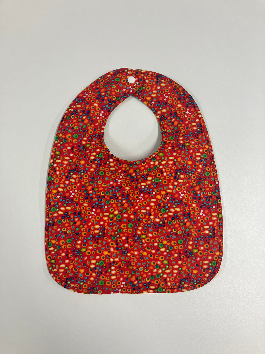 Reversible Bib – Green Dinosaurs / Red with Spots