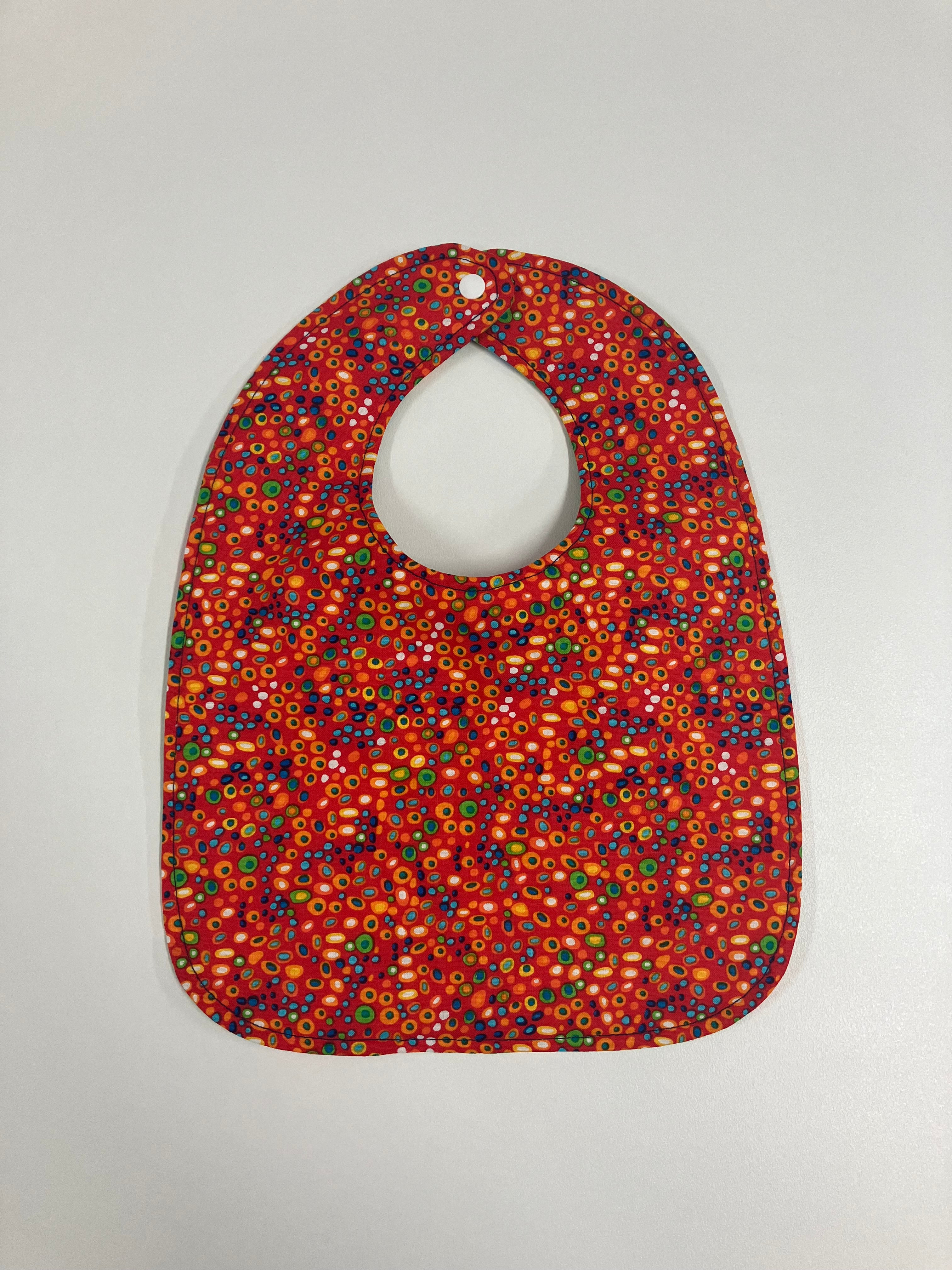 Reversible Bib – Green Dinosaurs / Red with Spots