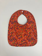 Reversible Bib – Blue Dinosaurs / Red with Spots