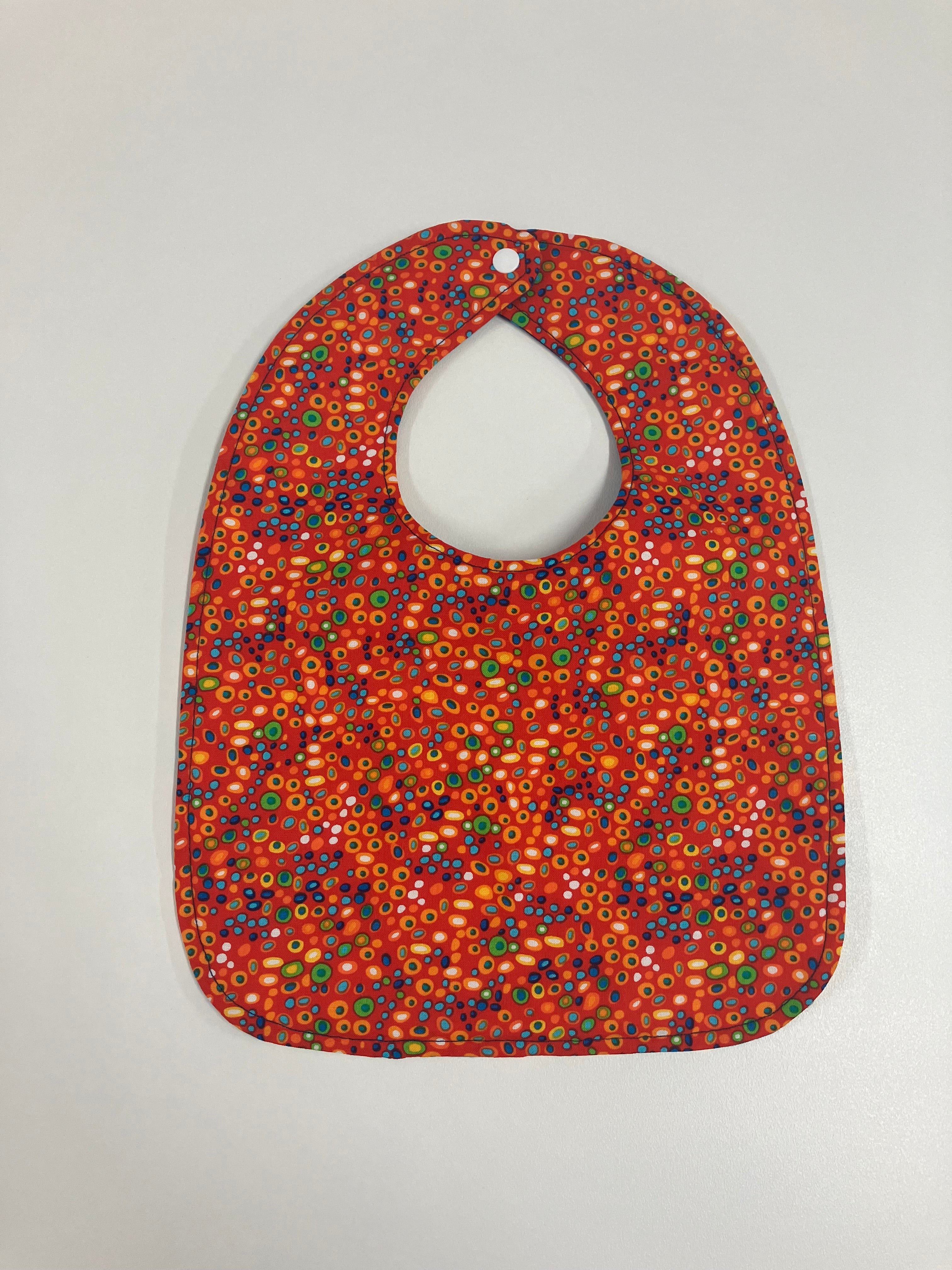Reversible Bib – Blue Dinosaurs / Red with Spots